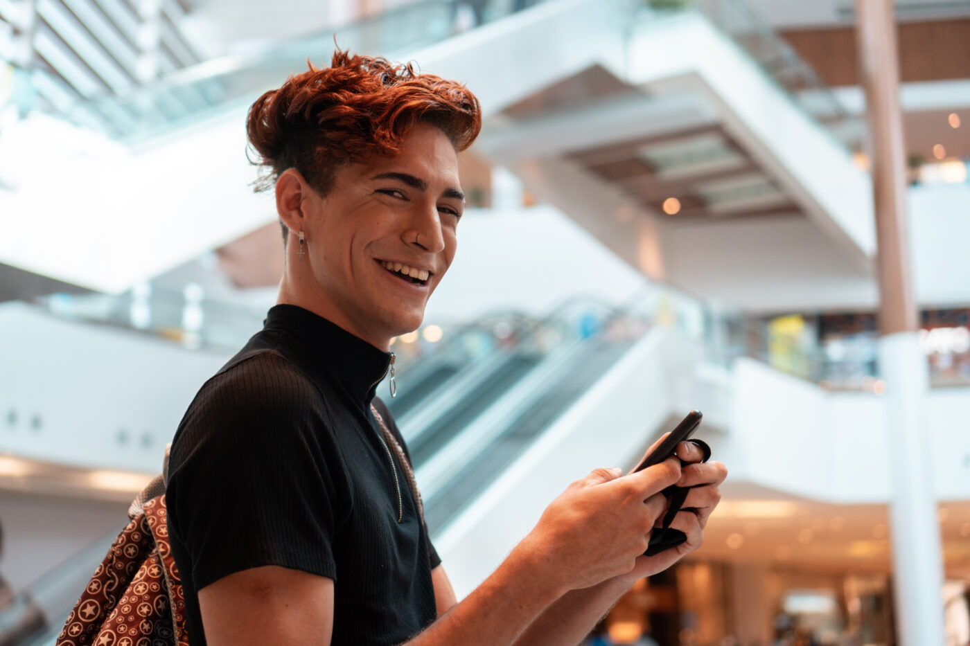 Gen Z person laughing and smiling on phone