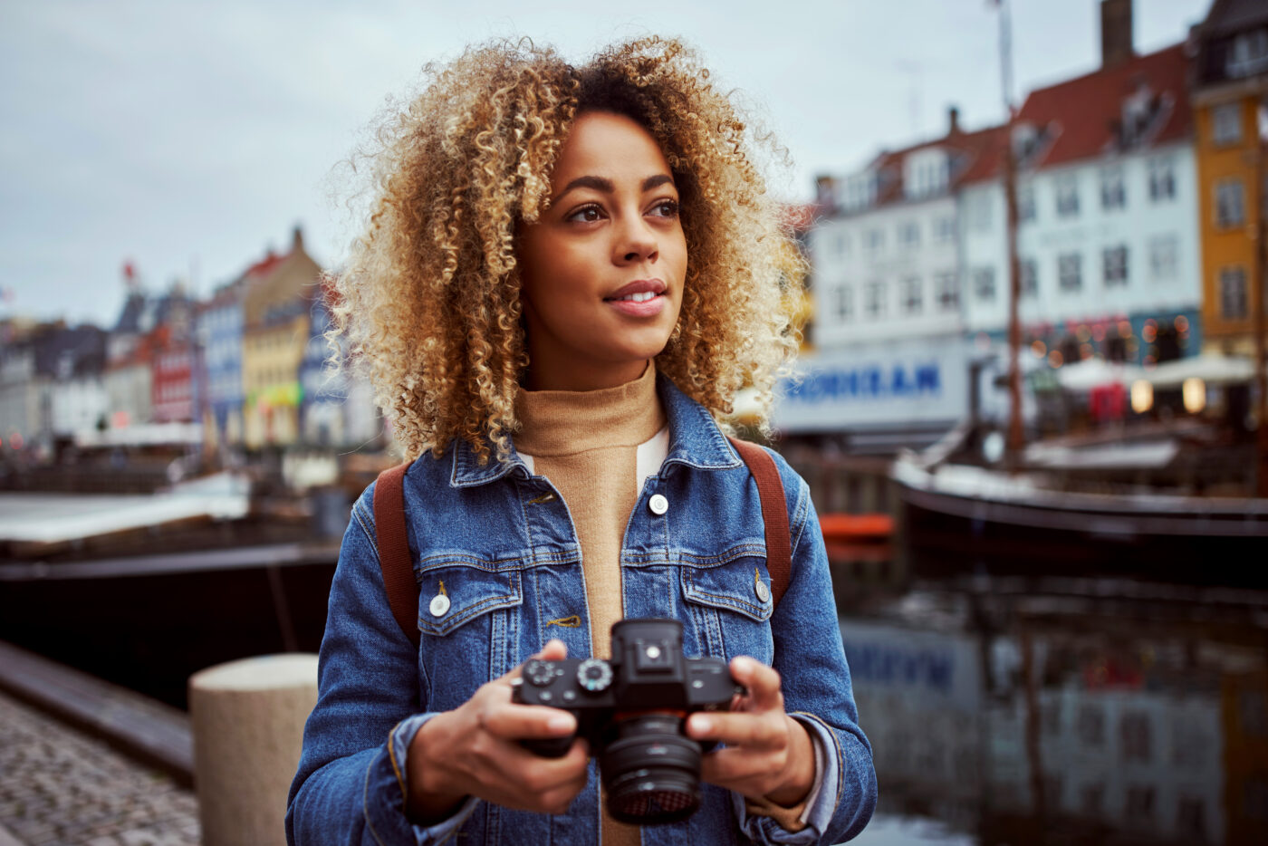 Gen Z woman on holiday using her camera