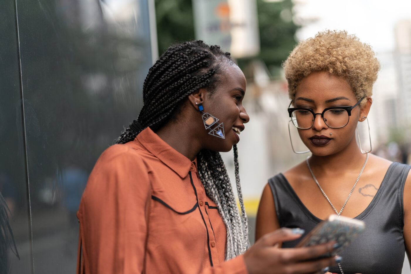 Two young Gen Z women looking at a phone 
